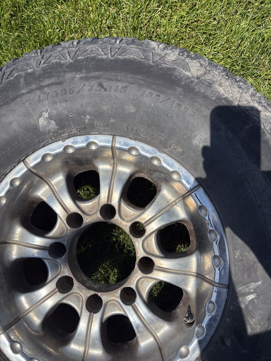 LT285/75R16 All-Terrain Tire with Chrome Rim - Good Tread and one black Rim from a f250 7.3
