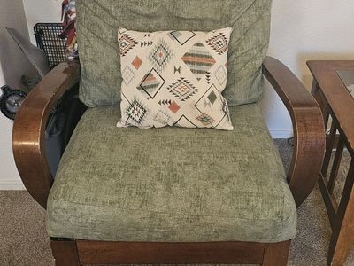 Green Upholstered Armchair with Curved Wooden Frame
