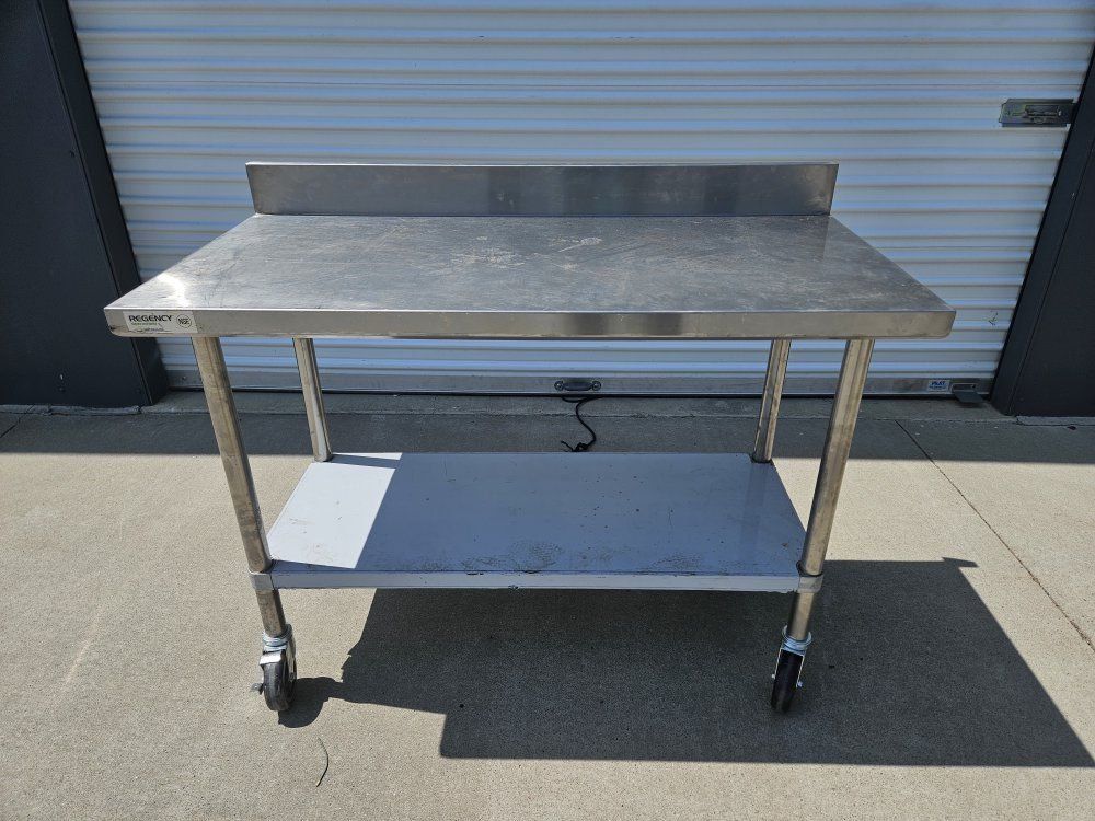 Regency Stainless Steel Prep Table with Backsplash, Undershelf, and Caster Wheels, 4 foot, Never used!