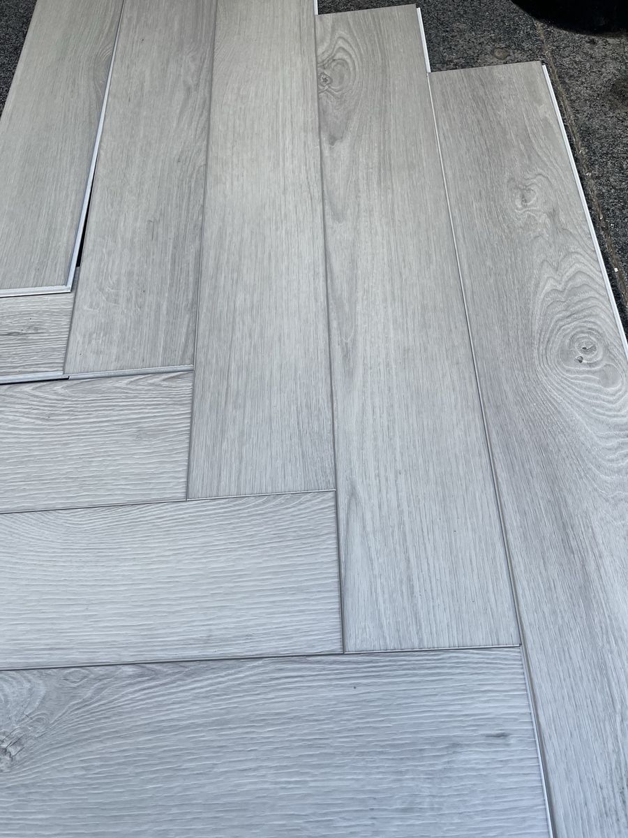 New Light Gray Wood Plank Vinyl Flooring - Multiple Pieces Available 200 square feet herringbone style.
