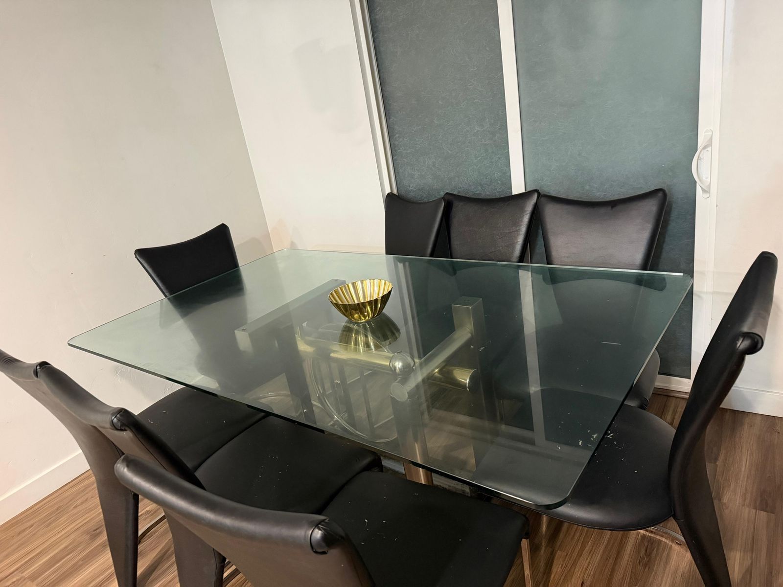Contemporary Glass Top Dining Table with Brass Base and 8 Black Leather Chairs