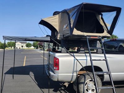 naturnest rooftop tent, hard top with 270 awning and awning enclosure , annex room and truck rack