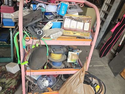 Rack full of assorted Garage Lot of Car Audio Speakers, Wire Nuts, and Hardware