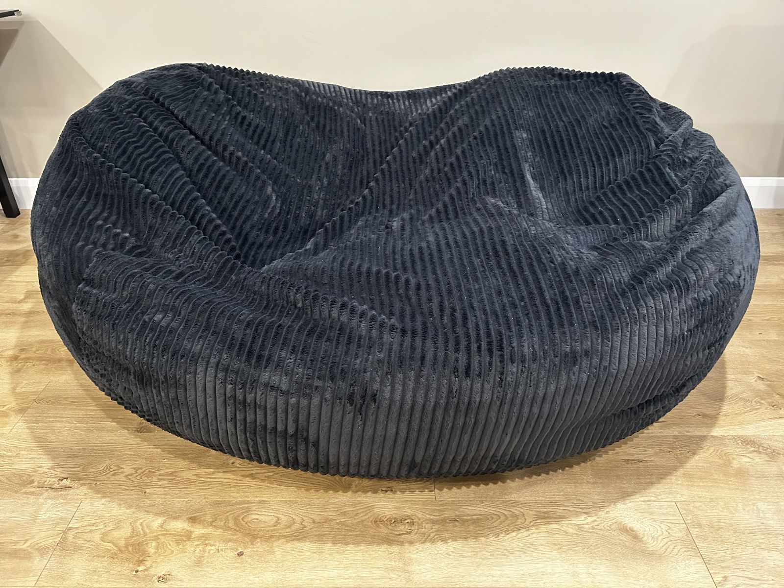 7 ft black bean bag with memory foam and leather handle.
