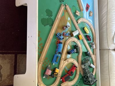 Train table with wooden tracks and trains