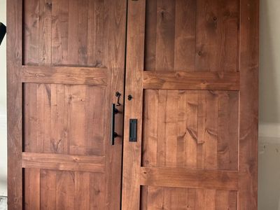 Stained Wood Sliding Barn Doors with Black Hardware