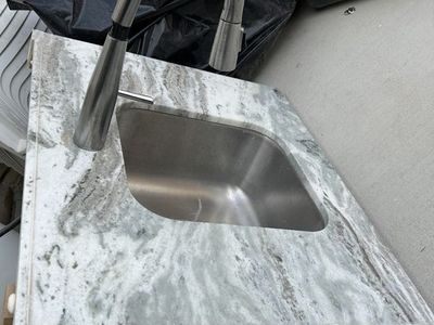 Gray & White Marble Style Countertop with Stainless Steel Sink and Faucet