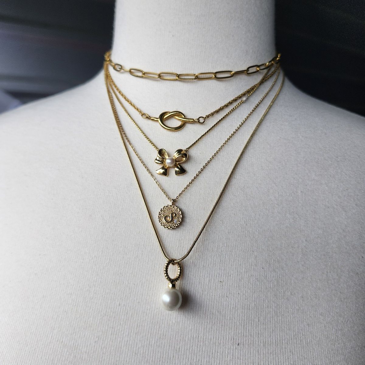 Vintage gold tone necklace stack lot. Trifari, Talbots, Lia Sophia, more.  Bows, knots, chains