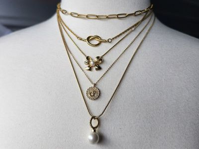 Vintage gold tone necklace stack lot. Trifari, Talbots, Lia Sophia, more. Bows, knots, chains