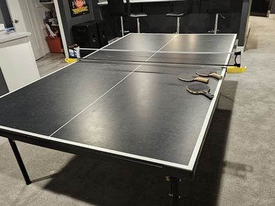Stiga Legacy Table Tennis Table featuring a black tabletop with white edge stripes.
