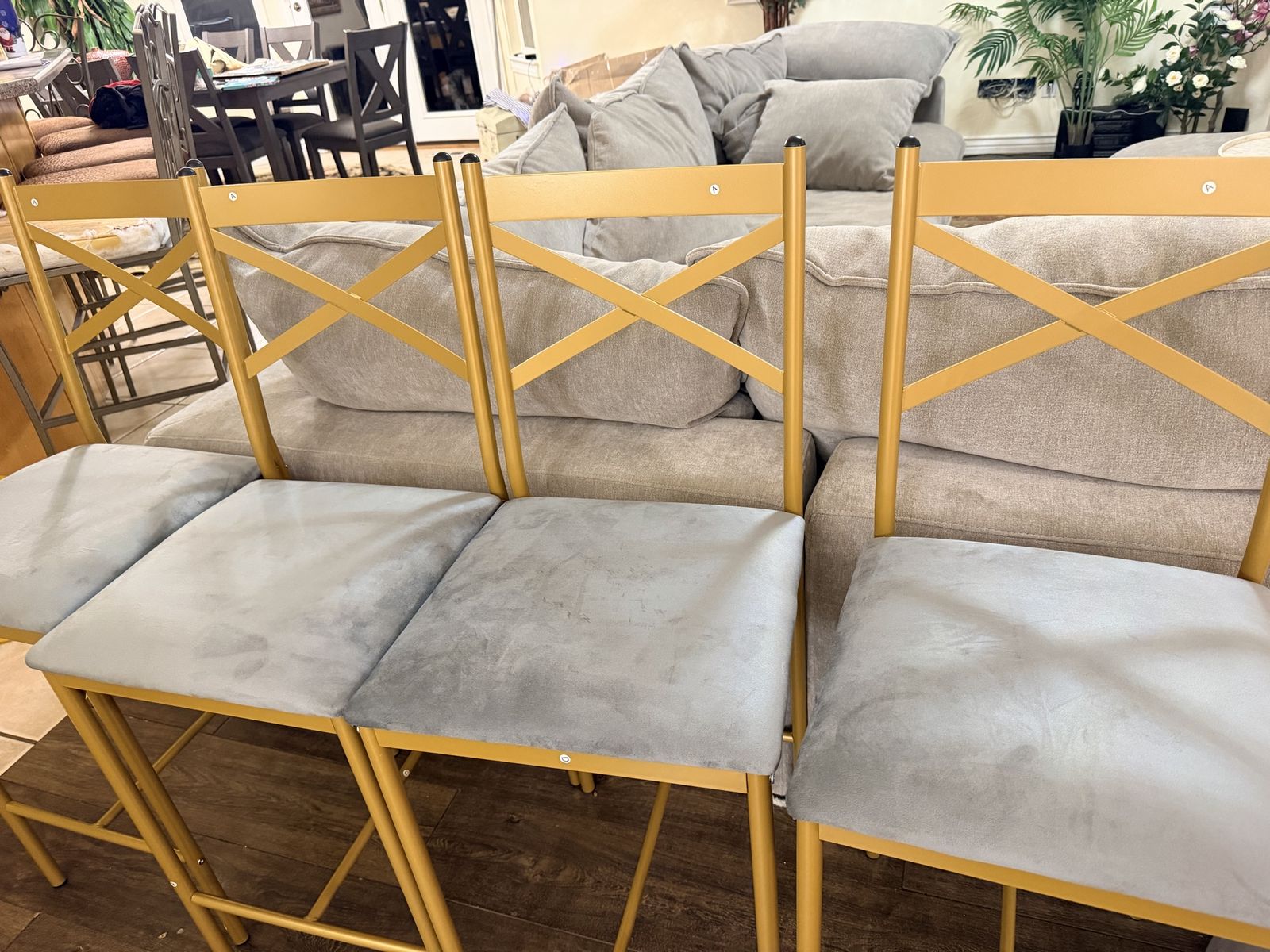 New. Set of 8 Gold Cross-Back Bar Stools with Grey Velvet Seats - Modern Counter Height Chairs. New and assembled ready to use.