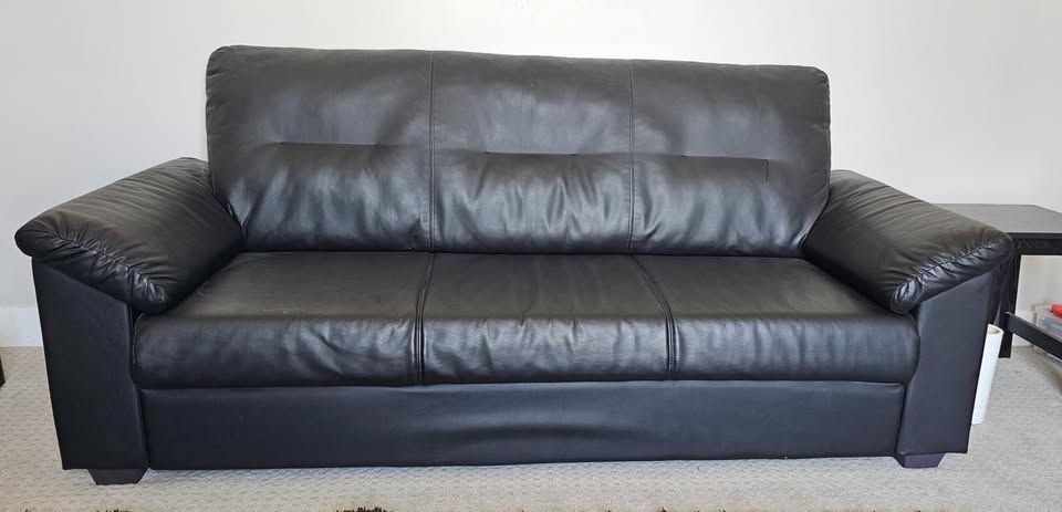 Black IKEA Knislinge sofa featuring a high back and pillow-top arms. In great condition.  Dimensions 36 h x 81 length x 34 width