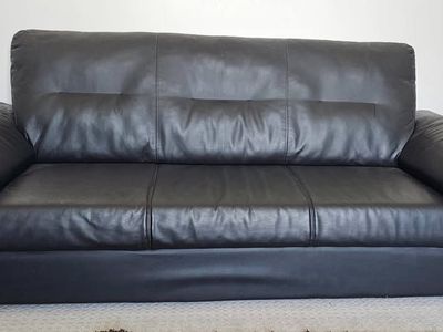 Black IKEA Knislinge sofa featuring a high back and pillow-top arms. In great condition. Dimensions 36 h x 81 length x 34 width
