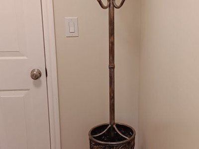 Standing coat hanger/umbrella holder.
