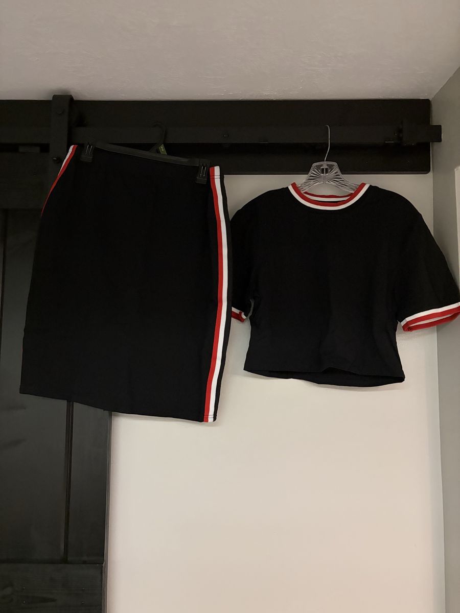 Brand new two piece black short sleeved top and skirt
