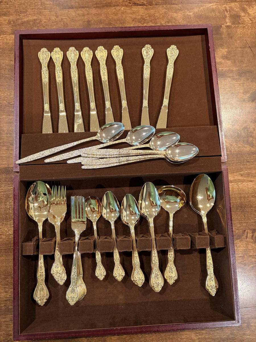 Gold stainless silverware set in beautiful condition set of 8 missing one small fork and one teaspoon. Has 7extra gold spoons