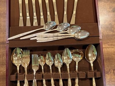 Gold stainless silverware set in beautiful condition set of 8 missing one small fork and one teaspoon. Has 7extra gold spoons