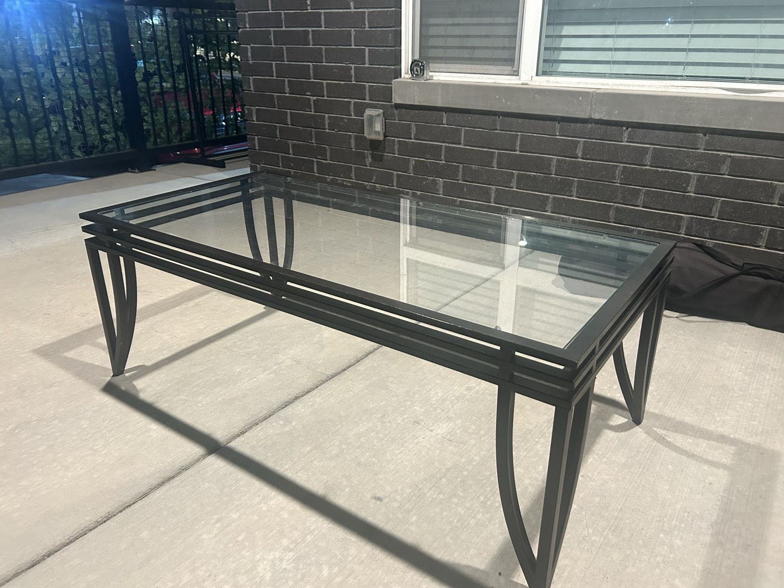 Glass top coffee table, black metal frame