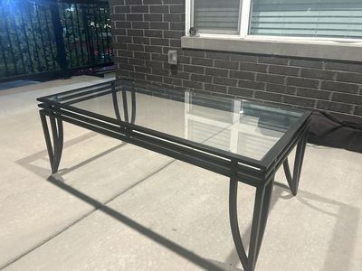 Glass top coffee table, black metal frame