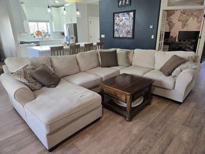 Beige Ashley Furniture sectional couch with chaise