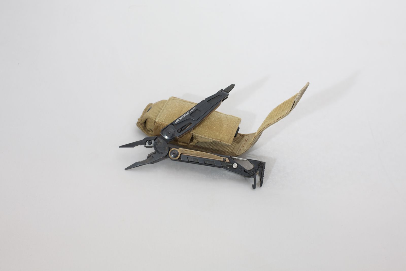 Leatherman MUT multi-tool with MOLLE-compatible sheath.