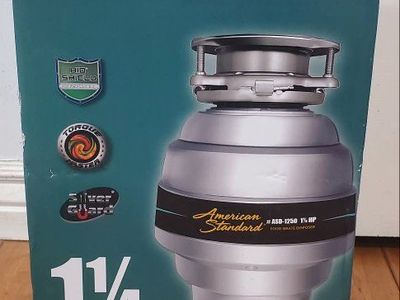 New American Standard 1 1/4 horsepower kitchen food waste disposer.