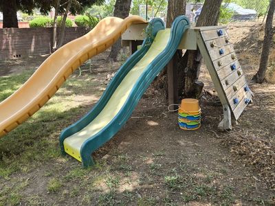 Used Backyard Playset with Double Slides and Climbing Wall - Perfect for Outdoor Fun