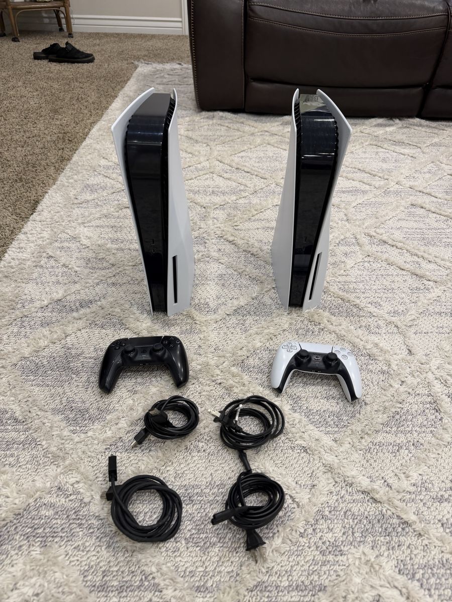 Two PlayStation 5 Consoles with Controllers and Power Cords