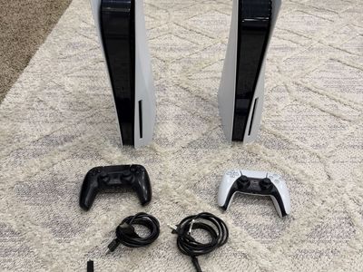 Two PlayStation 5 Consoles with Controllers and Power Cords