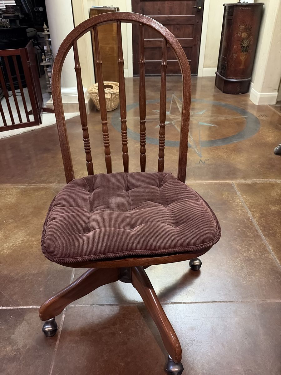 Vintage swivel and wooden brown rolling chair with cushion