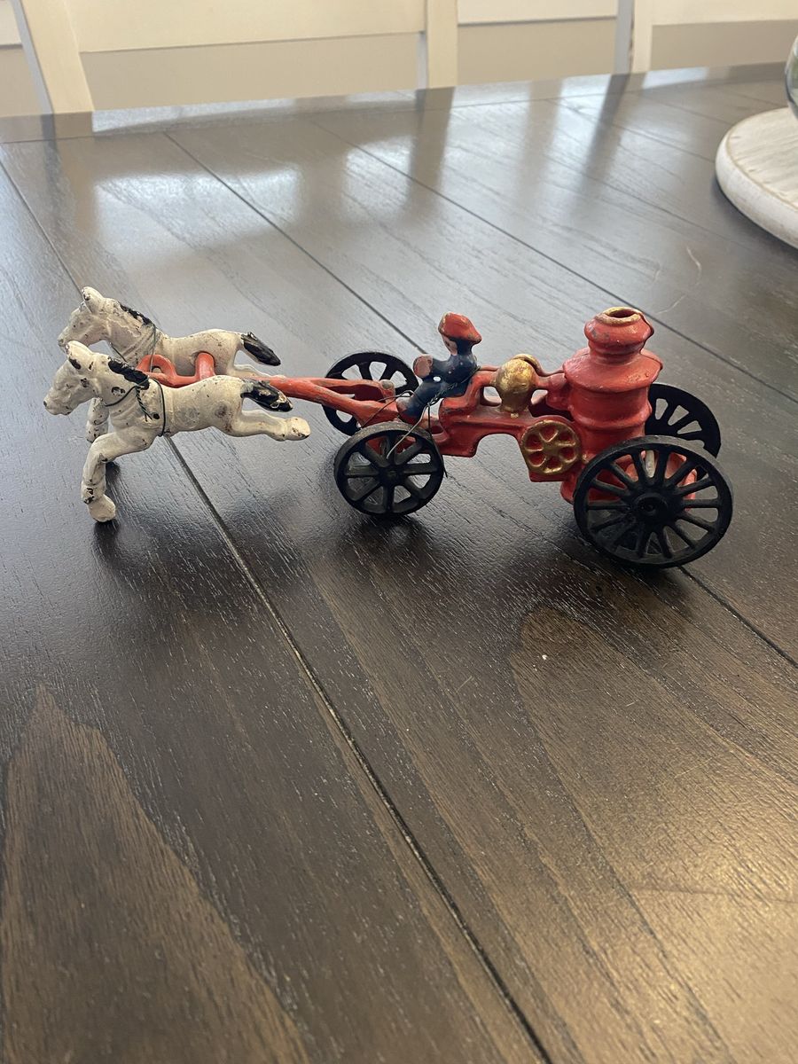 Cast iron horse-drawn fire wagon with fireman