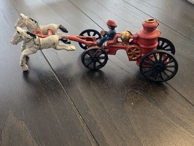 Cast iron horse-drawn fire wagon with fireman