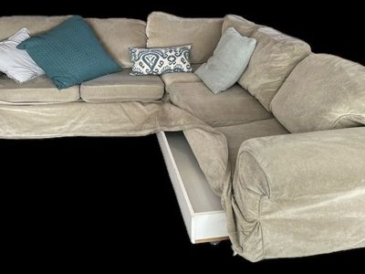 Sectional couch with tan washable cover , trundle bed and storage. Used