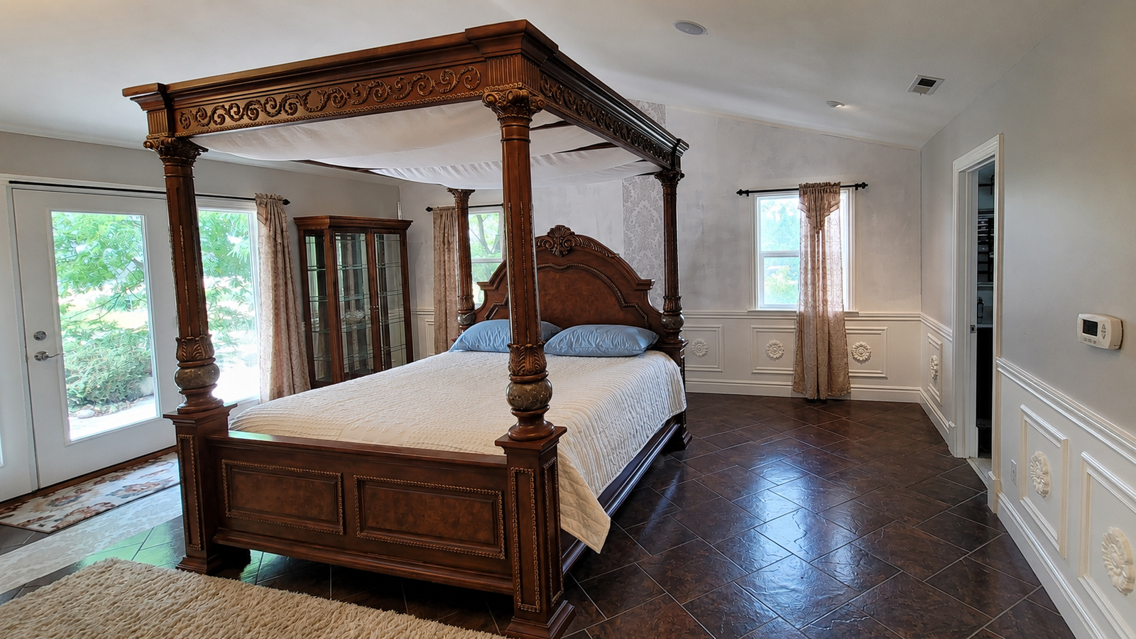 Ornate Wooden Four-Poster Canopy Bed Frame with Intricate Carved Detailing