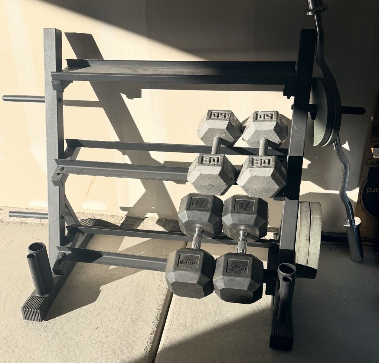 Dumbbells, 50lbs and 70’s plus rack