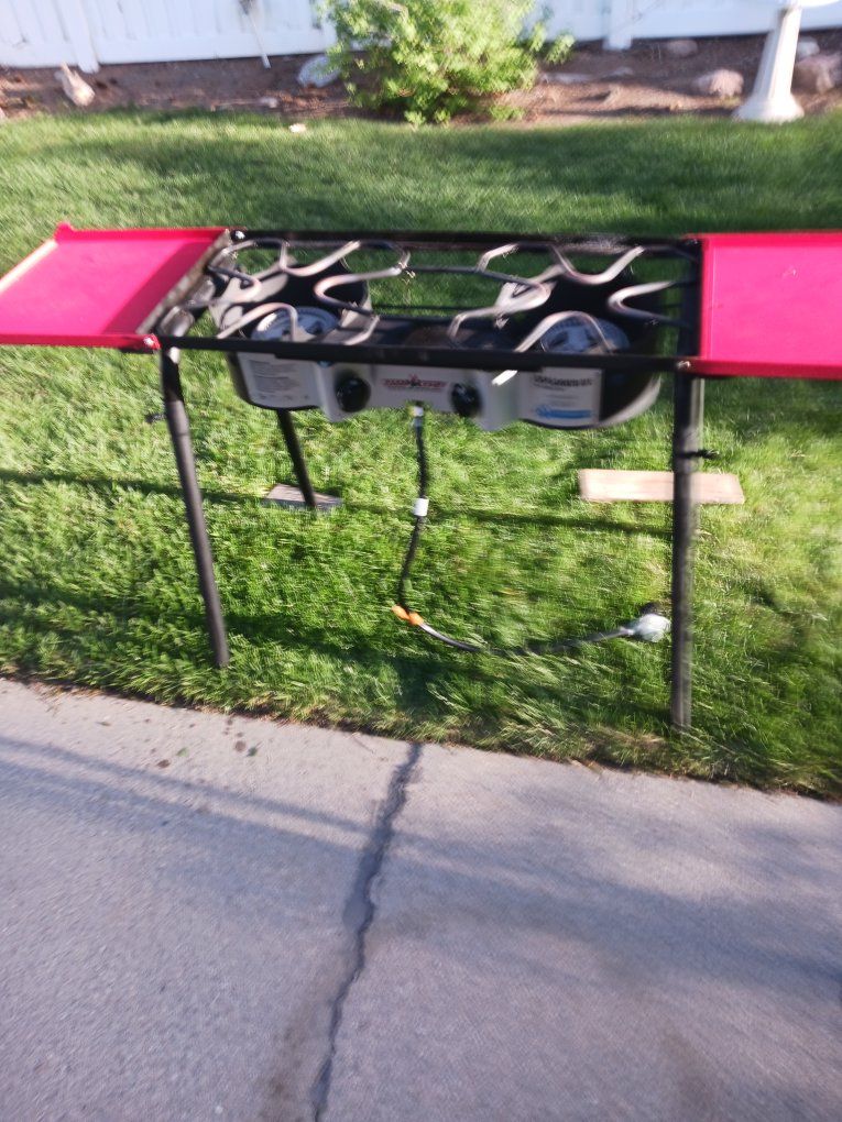 Camp Chef Explorer 14"  double burner stove with folding shelves, and storage bag