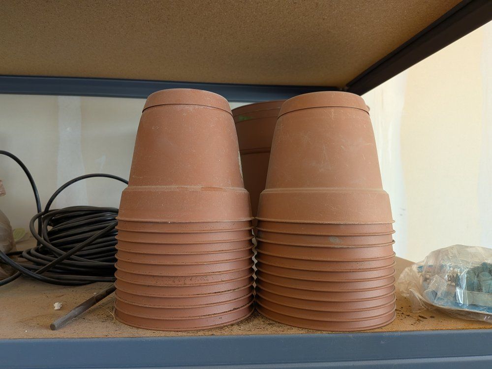 24 plastic terracotta colored plant pots
