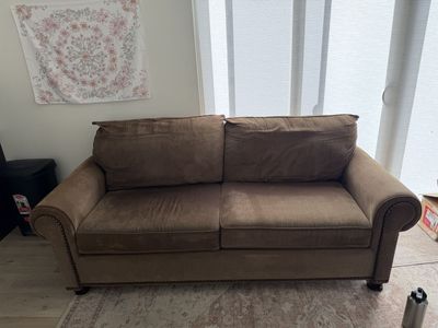 Brown fabric sofa with nailhead trim