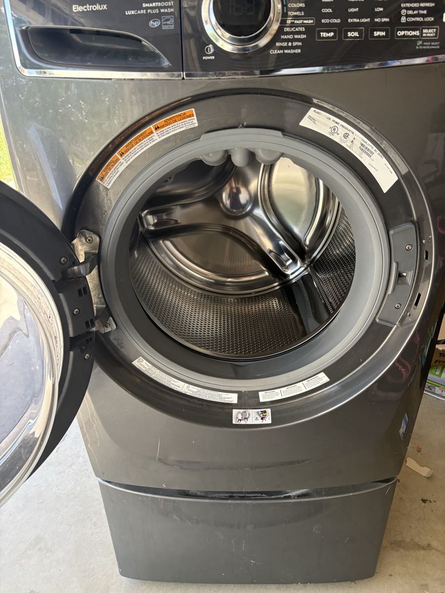 Front load Electrolux Washer and stand.