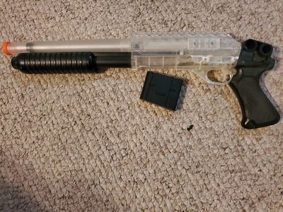 Shotgun-style spring-powered airsoft gun
