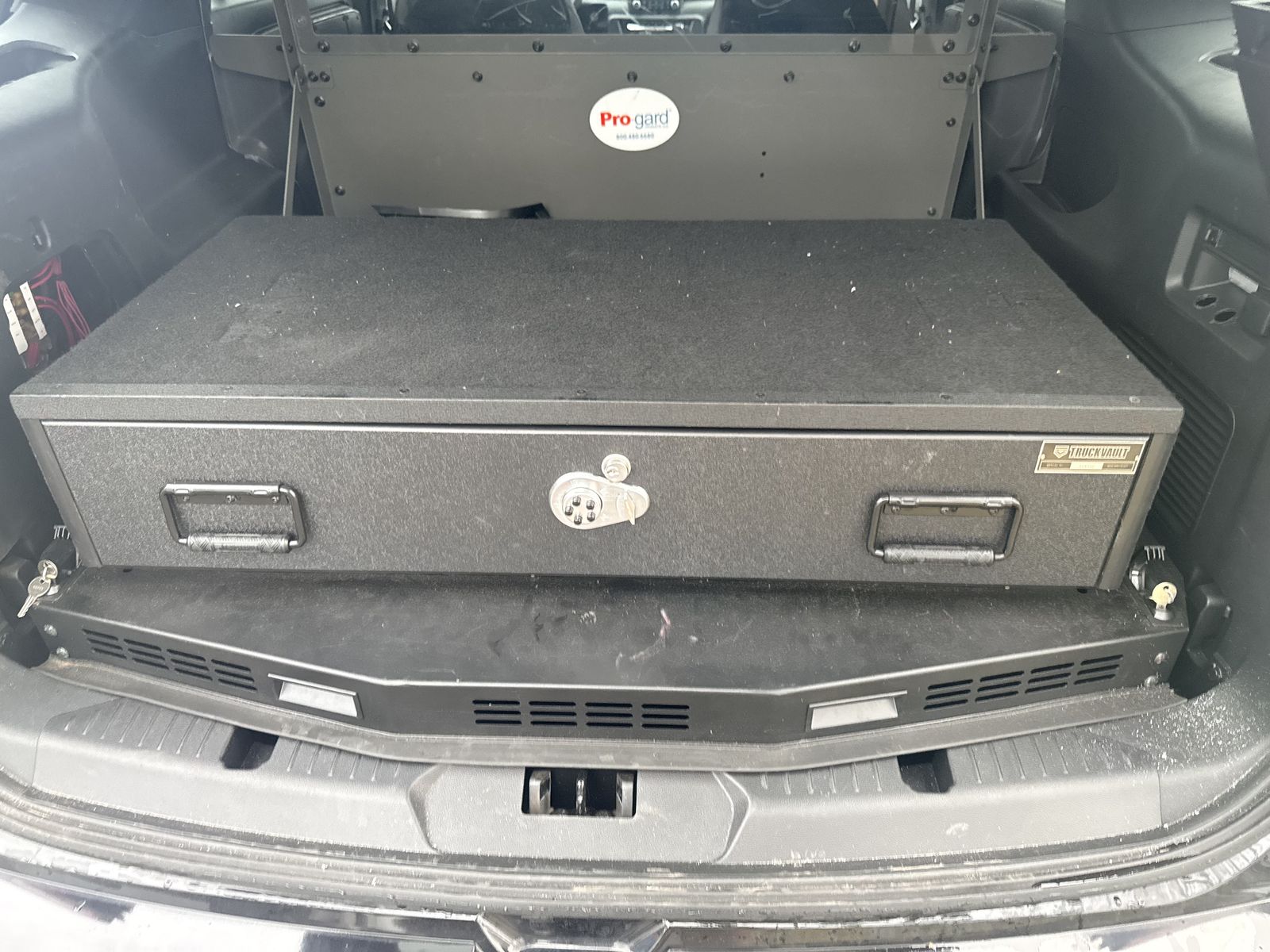 Durable TRUCKVAULT cargo storage drawer. Is black and has a lock and handles. Good for keeping your gear secure in a vehicle.