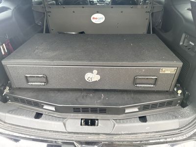 Durable TRUCKVAULT cargo storage drawer. Is black and has a lock and handles. Good for keeping your gear secure in a vehicle.