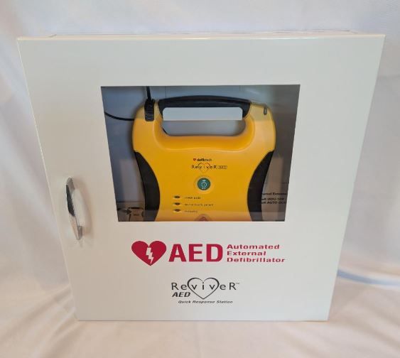 AED (Defibrillator) with Cabinet / Pads dated 1/2028 Battery dated 5/2028 / Instruction Book / Extras