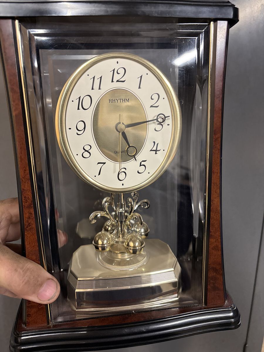 Clock With Rotating Pendulum