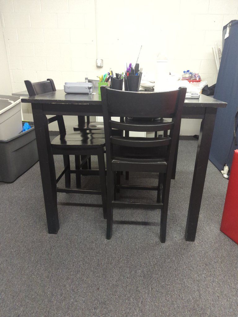 bar height table and four chairs