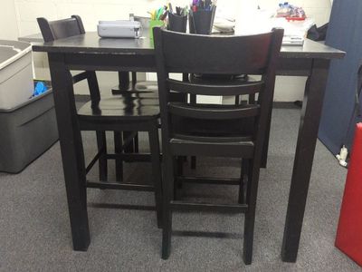 bar height table and four chairs