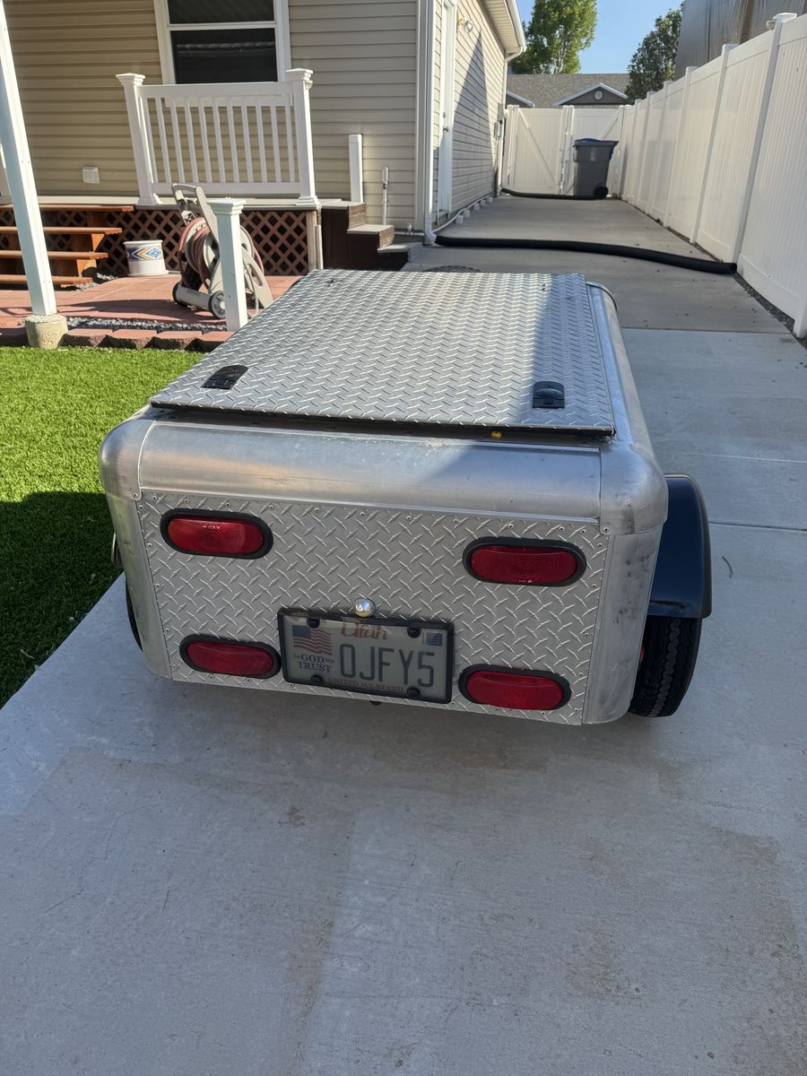 Cargo trailer can be towed behind a car or motorcycle