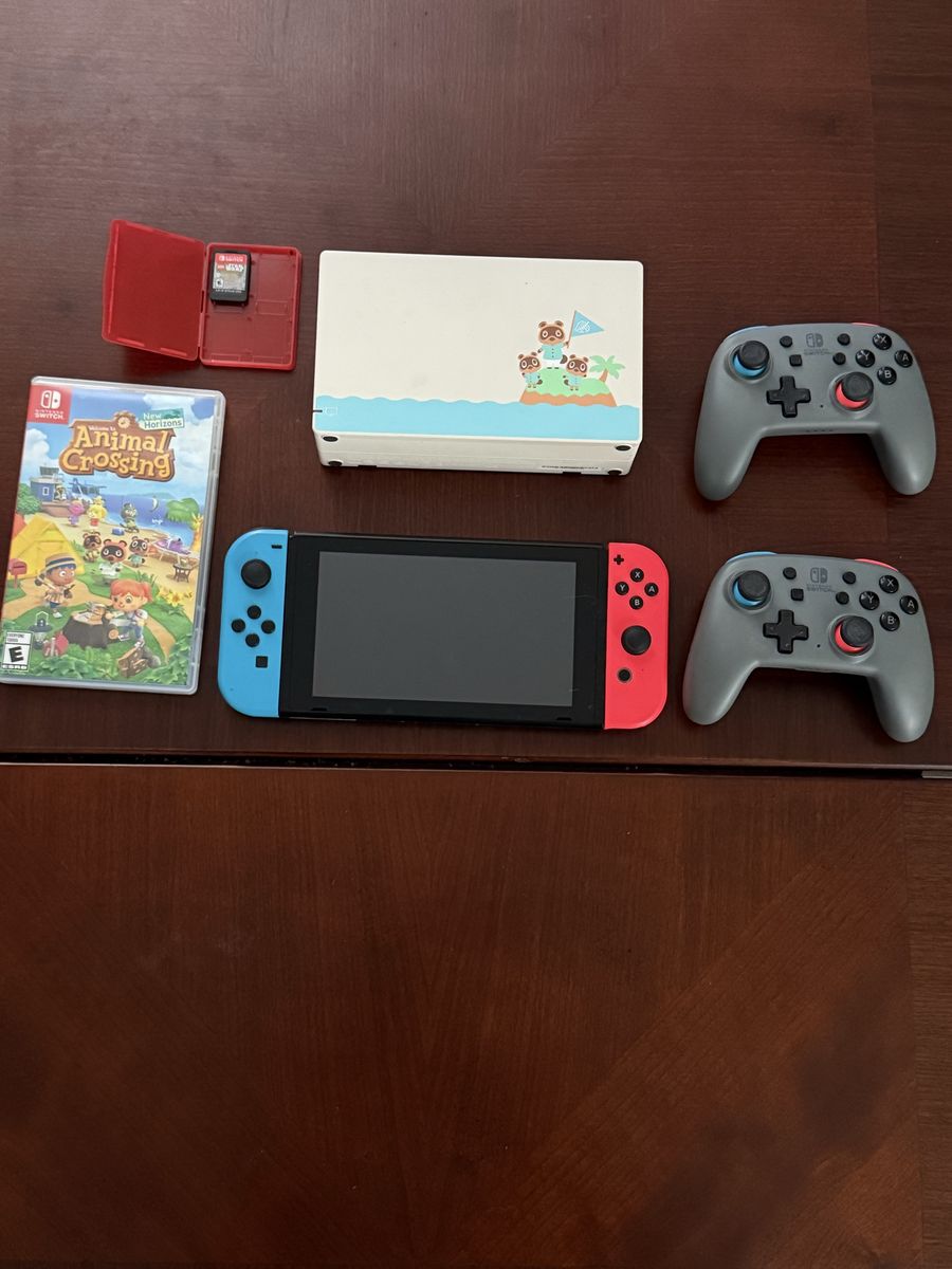 Nintendo switch with two games and two pro controllers