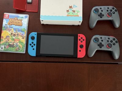 Nintendo switch with two games and two pro controllers