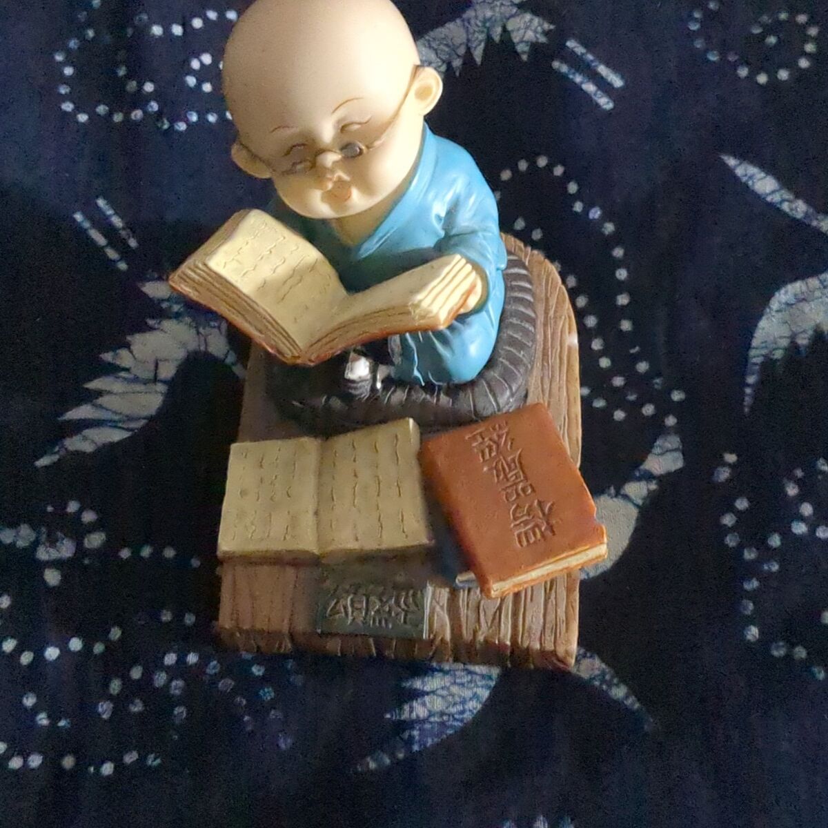 Bald monk with glasses figurine
